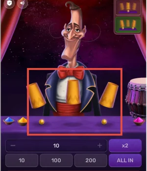 Mr. Thimble easy mode interface showing two yellow balls placed under three shuffled golden cups on a purple table.